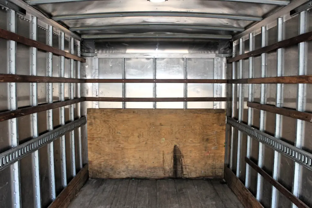 2019 Isuzu NPR HD box truck cargo area viewed from rear opening