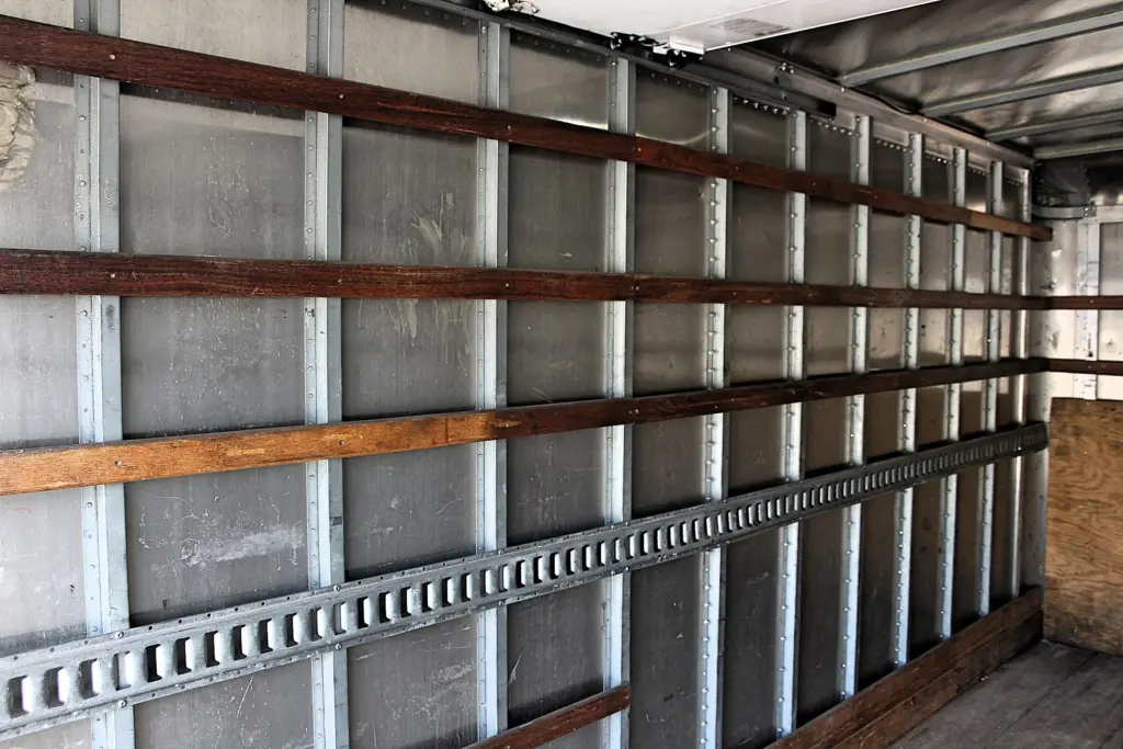 2019 Isuzu NPR HD cargo box interior rear section with side rails