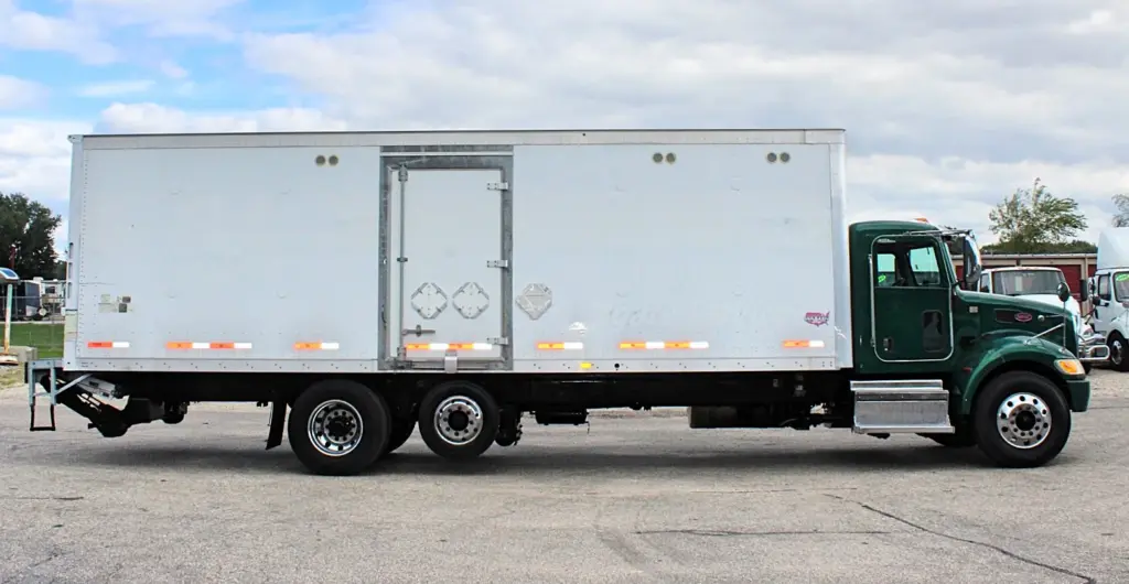 2018 Peterbilt 348 box truck – passenger-side profile showing white cargo box and side access door