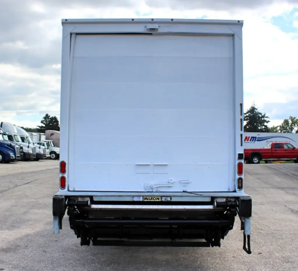 2018 Peterbilt 348 box truck – straight rear view showing roll-up cargo door and Maxon liftgate