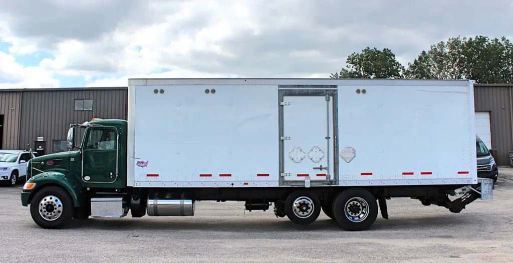 2018 Peterbilt 348 box truck – full driver-side profile with tandem rear axle and side cargo door