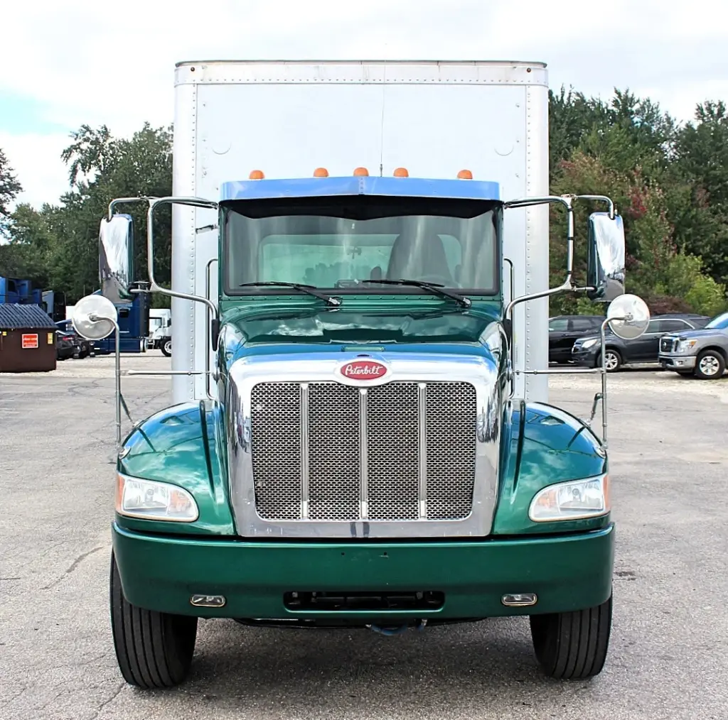 2018 Peterbilt 348 box truck – straight front view showing chrome Peterbilt grille and green cab