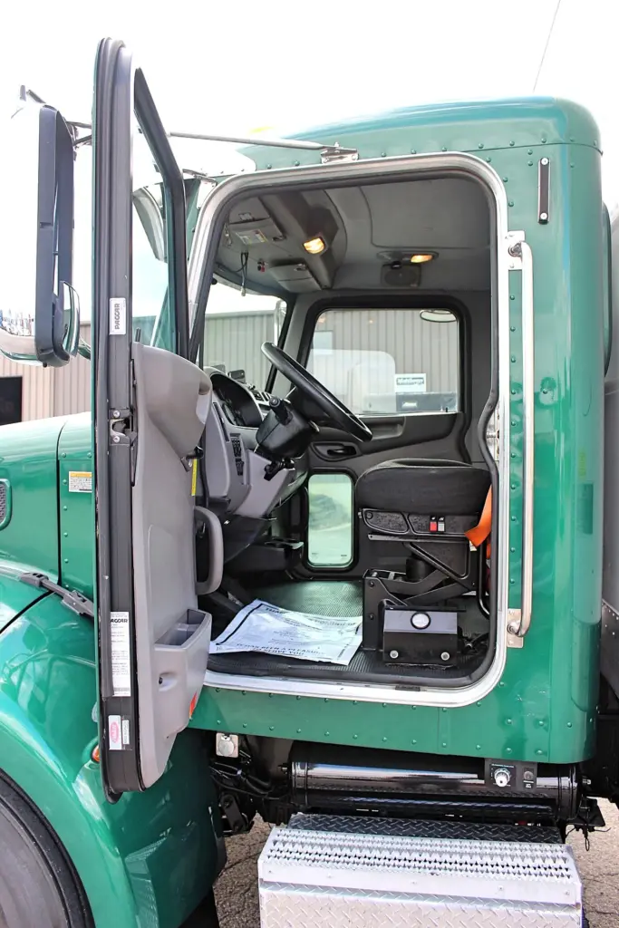 2018 Peterbilt 348 box truck – open driver door showing cab entry, seat and interior