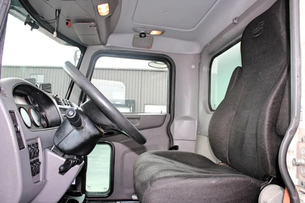 2018 Peterbilt 348 box truck – driver cab interior showing steering wheel and driver seat