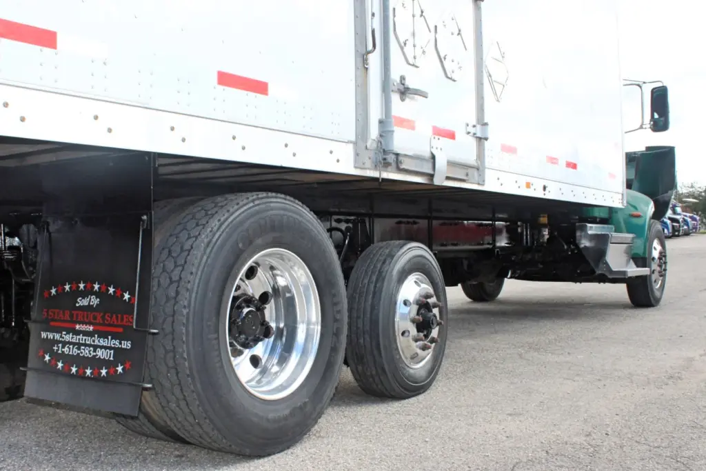 2018 Peterbilt 348 box truck – low-angle view of tandem rear wheels and underbody
