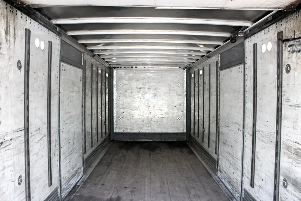 2018 Peterbilt 348 box truck – full cargo box interior view showing wood floor and wall rails