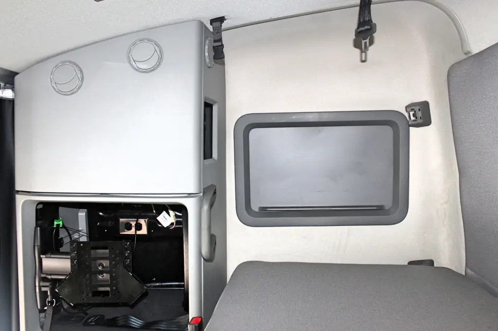 2024 Volvo VNL 760 sleeper - bunk area with storage cabinet and open equipment compartment