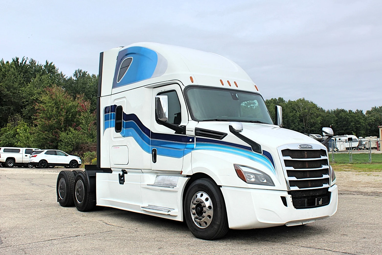 2019 Freightliner Cascadia 126 – white sleeper semi truck front passenger-side three-quarter exterior view