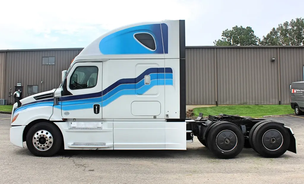 2019 Freightliner Cascadia 126 – driver-side profile exterior view of white sleeper semi truck