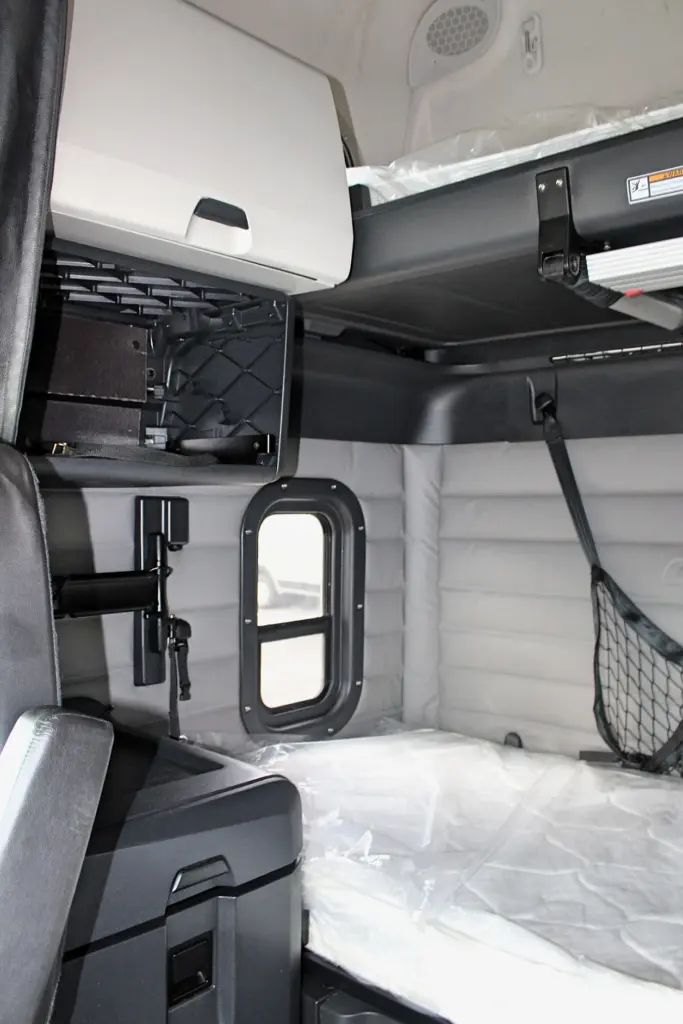 2019 Freightliner Cascadia 126 – sleeper interior with double bunk, storage cabinet and side window