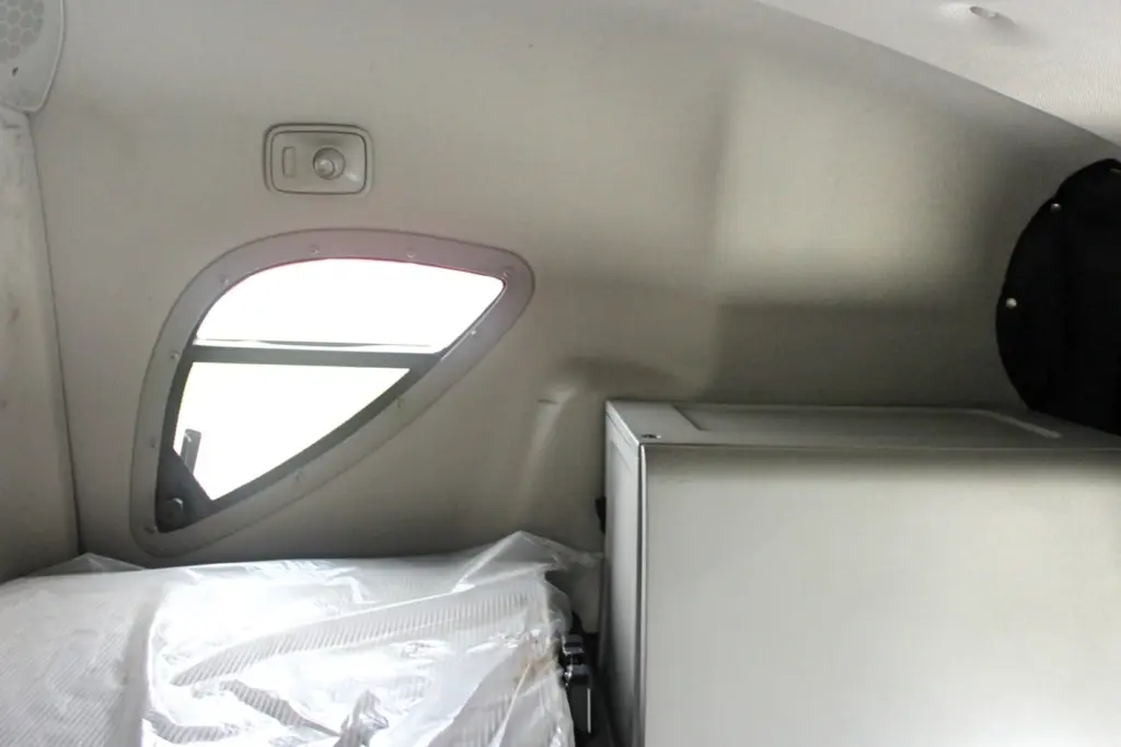 2019 Freightliner Cascadia 126 – sleeper bunk area with side window, mattress and storage cabinet