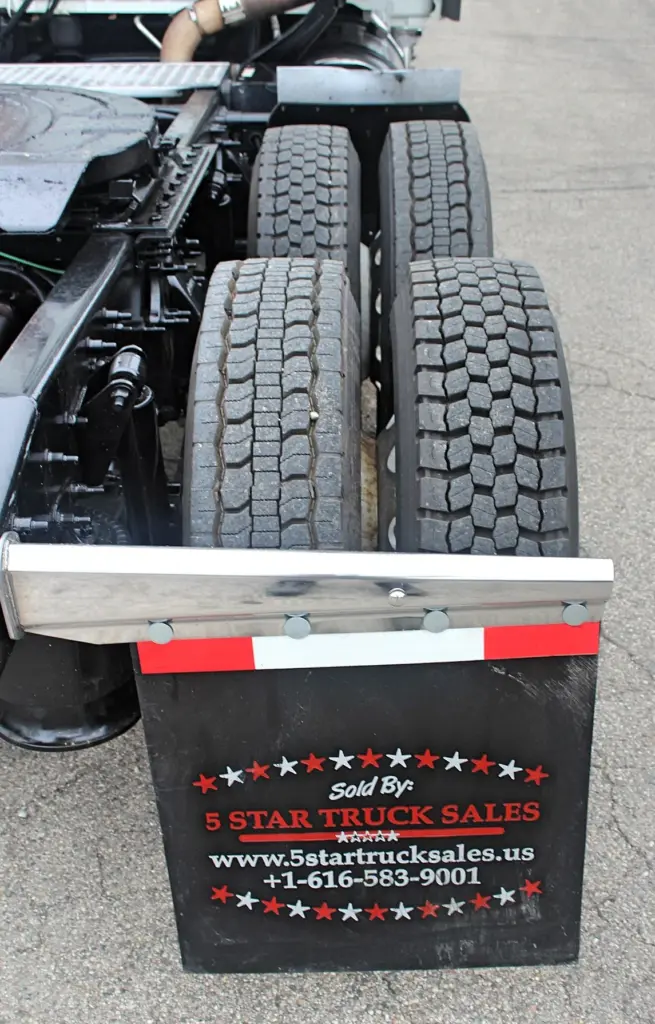 2019 Freightliner Cascadia 125 – Rear tire tread and mud flap close-up