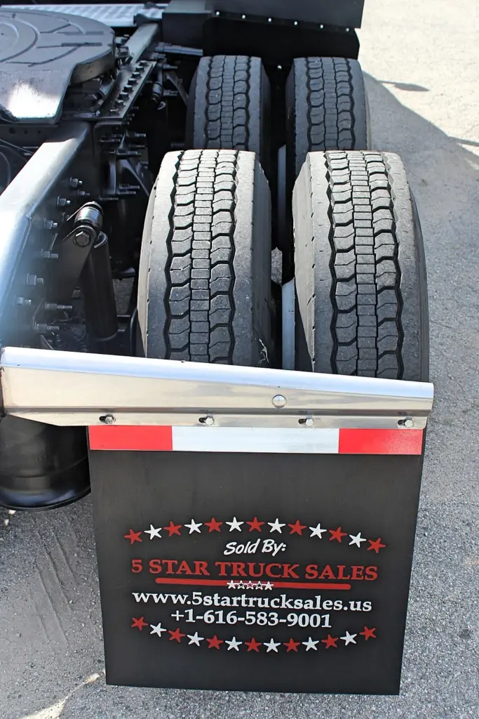 2020 Freightliner Cascadia 125 – passenger-side rear dual tires and mudflap close-up