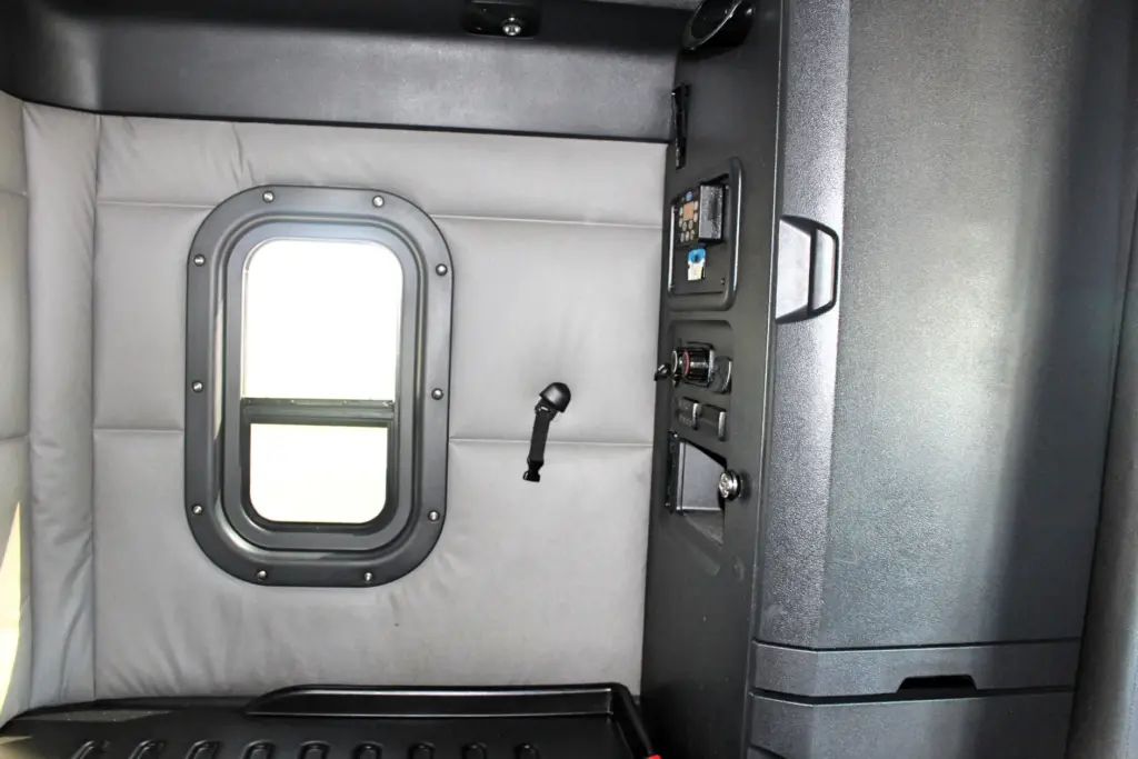 2020 Freightliner Cascadia 125 – sleeper interior with side window, bunk and rear storage cabinet