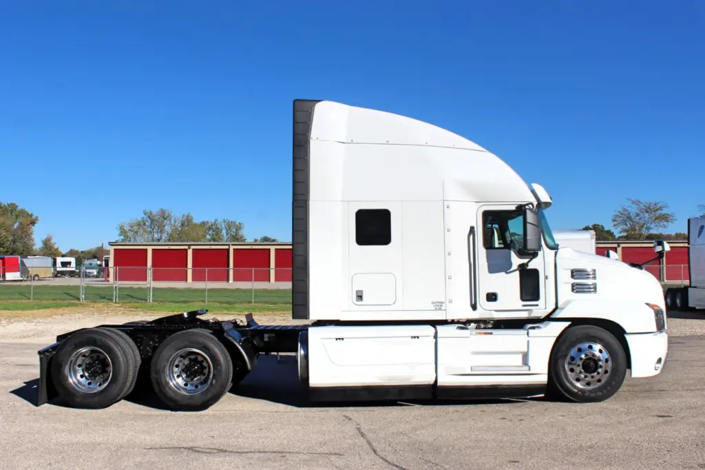 2023 Mack Anthem — full passenger-side profile of white high-roof sleeper tractor with tandem rear axle and polished wheels