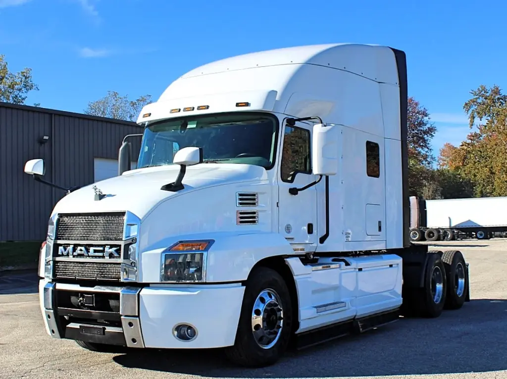 2023 Mack Anthem — front three-quarter view of white sleeper cab with chrome Mack grille, amber marker lights and mirrors