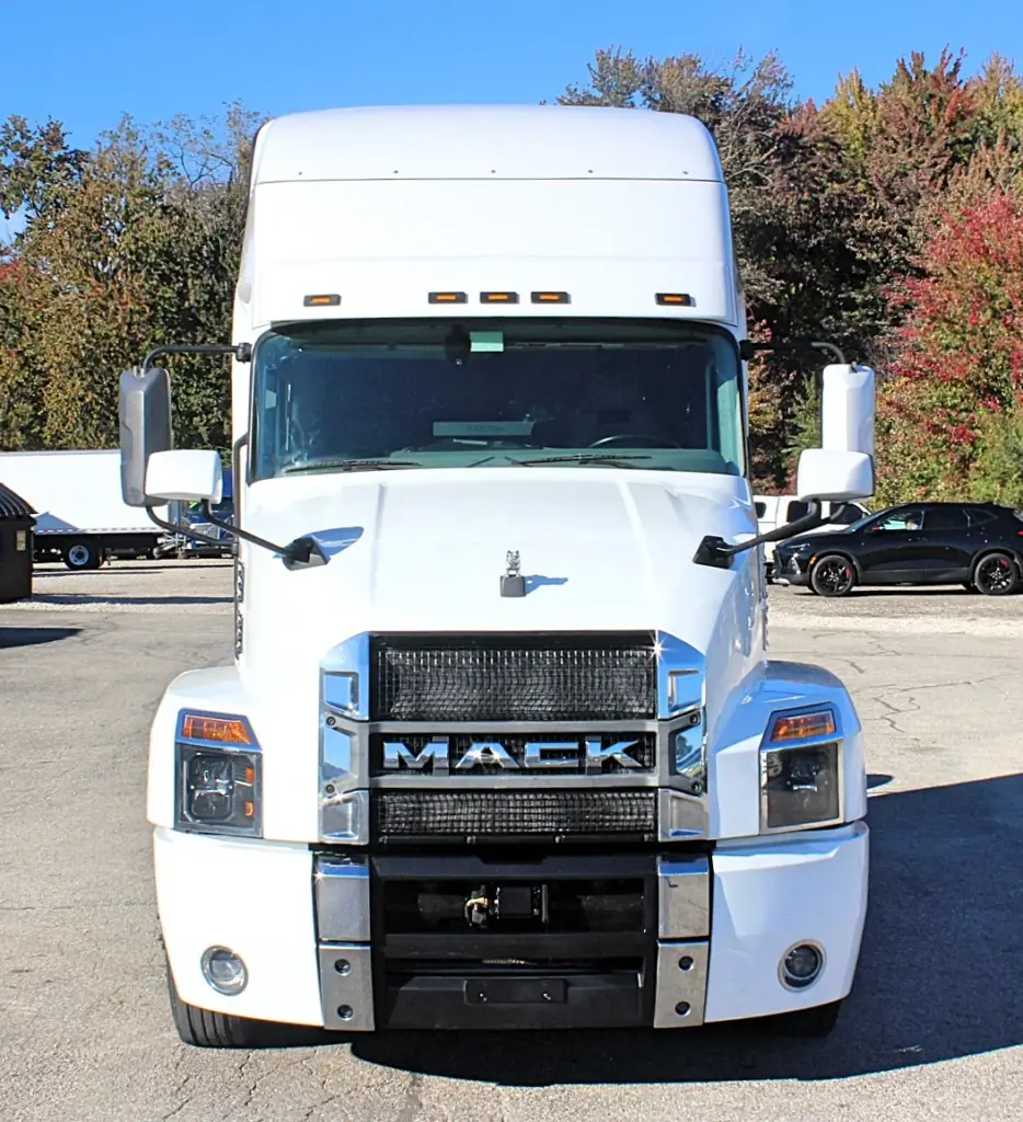 2023 Mack Anthem — straight front view of white high-roof sleeper with chrome Mack lettering, mesh grille and bumper