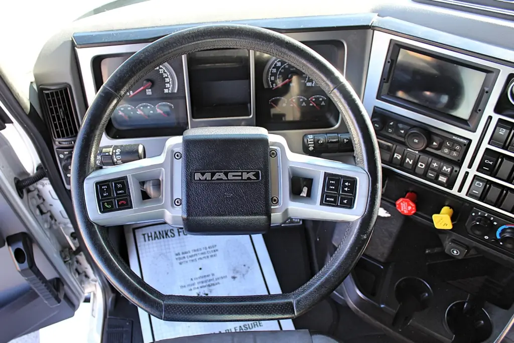 2023 Mack Anthem — steering wheel with Mack badge, audio and cruise buttons, analog gauges, touchscreen and shifter buttons