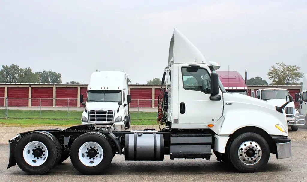 2019 International LT625 – passenger-side profile of white day cab semi truck.