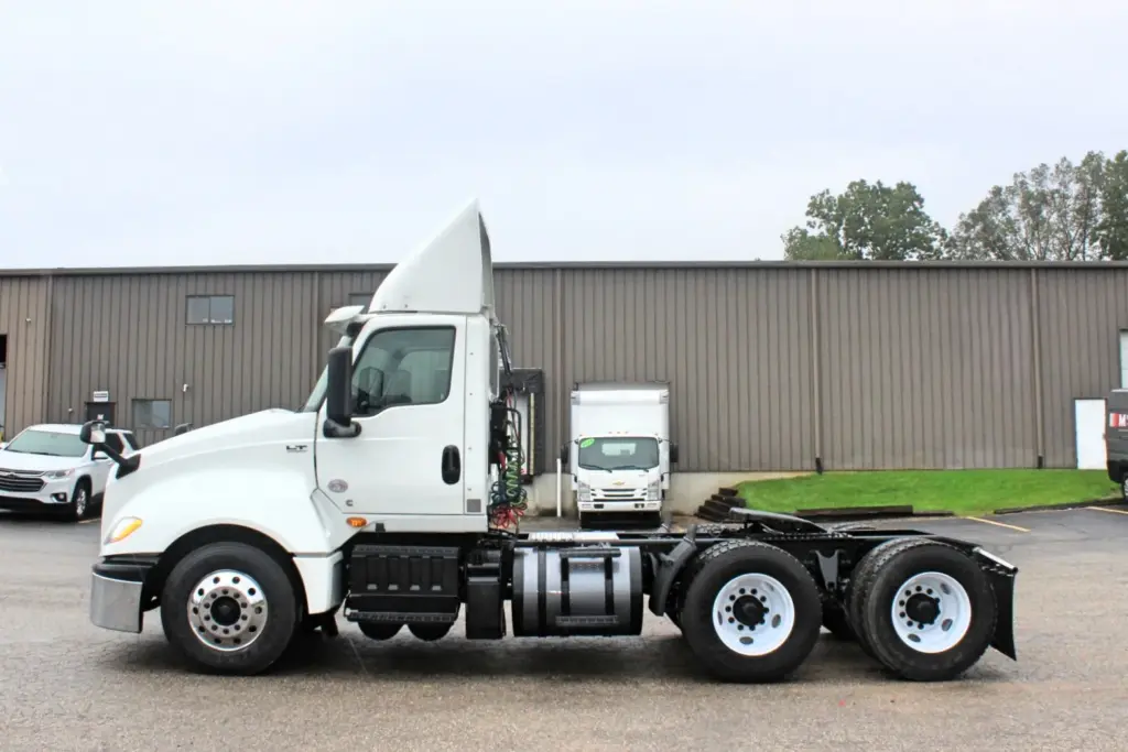 2019 International LT625 – driver-side profile of white day cab semi truck.