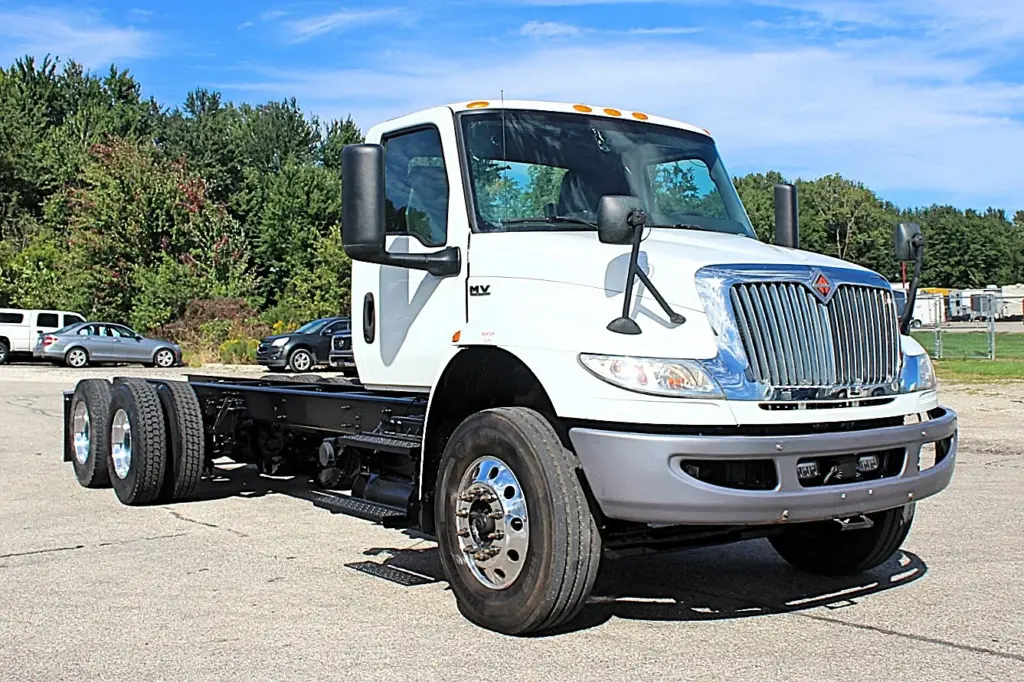 2020 International MV607 – front three-quarter view of white tandem axle cab and chassis truck