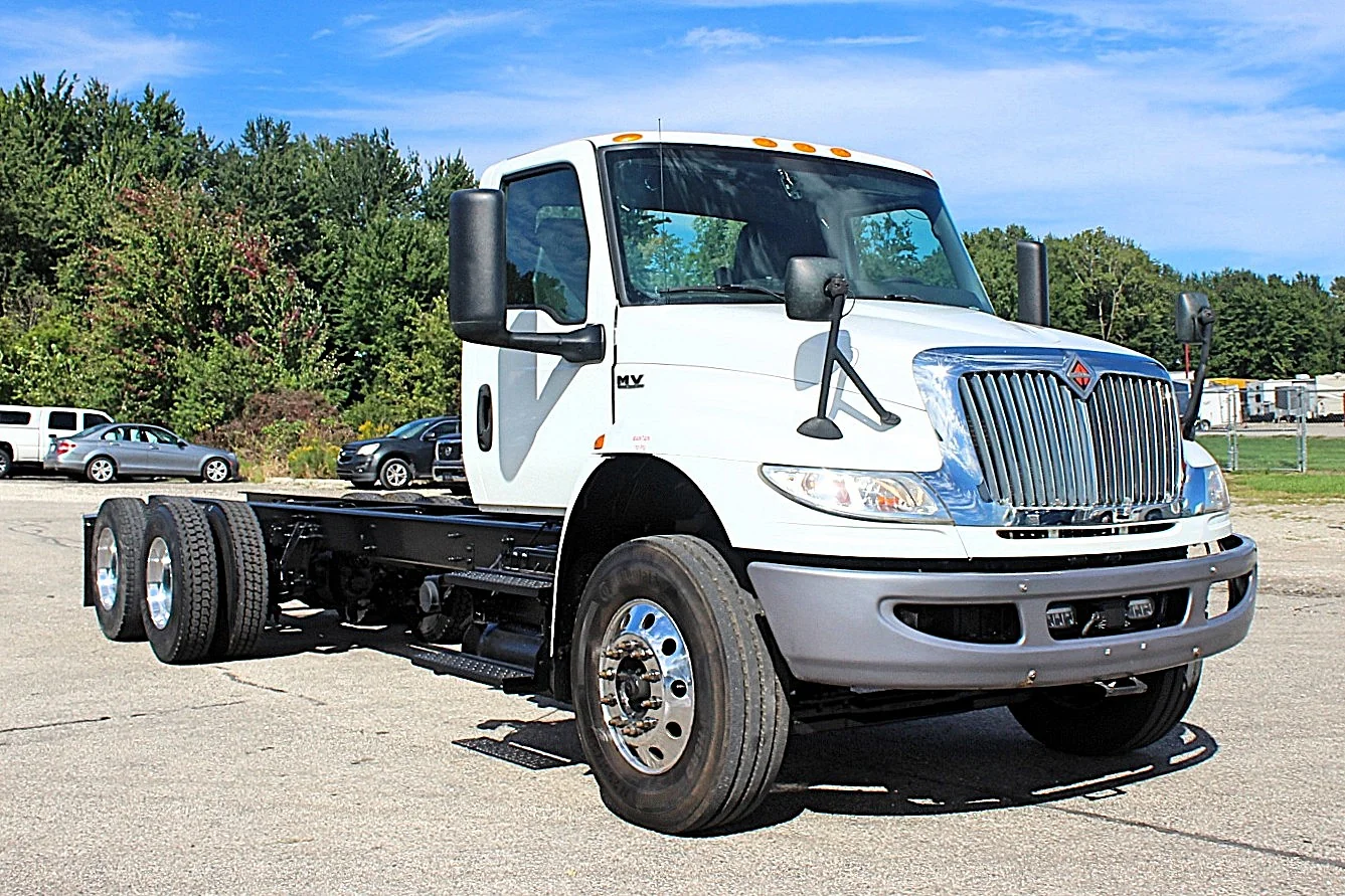 2020 International MV607 – front three-quarter view of white tandem axle cab and chassis truck
