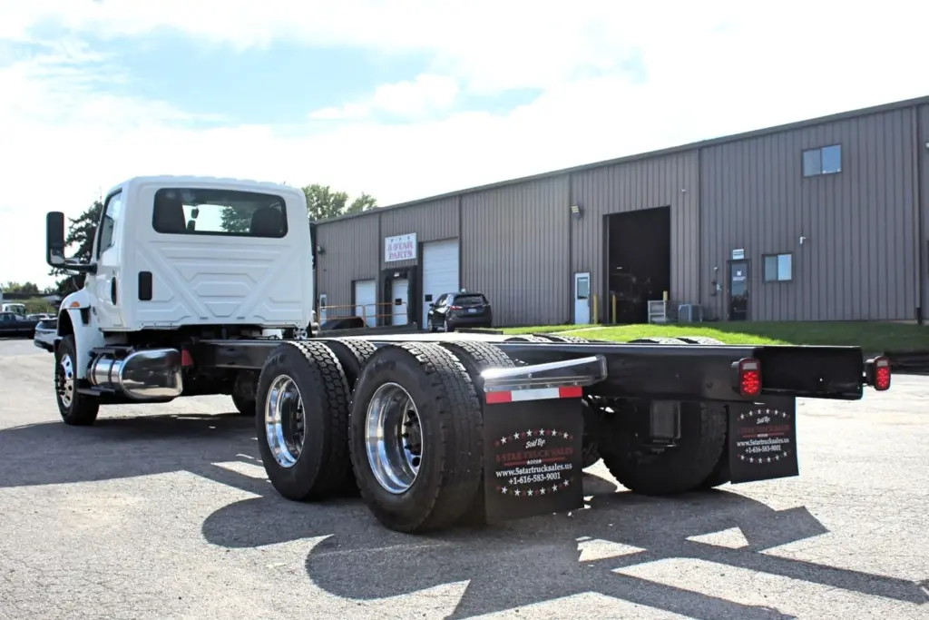 2020 International MV607 – rear driver side view of frame and tandem axles