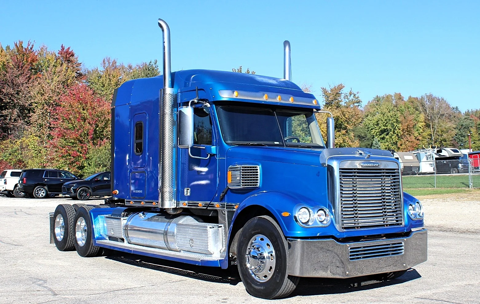 2016 Freightliner Coronado 132 — front three-quarter view of a blue sleeper with tall chrome stacks and aluminum wheels