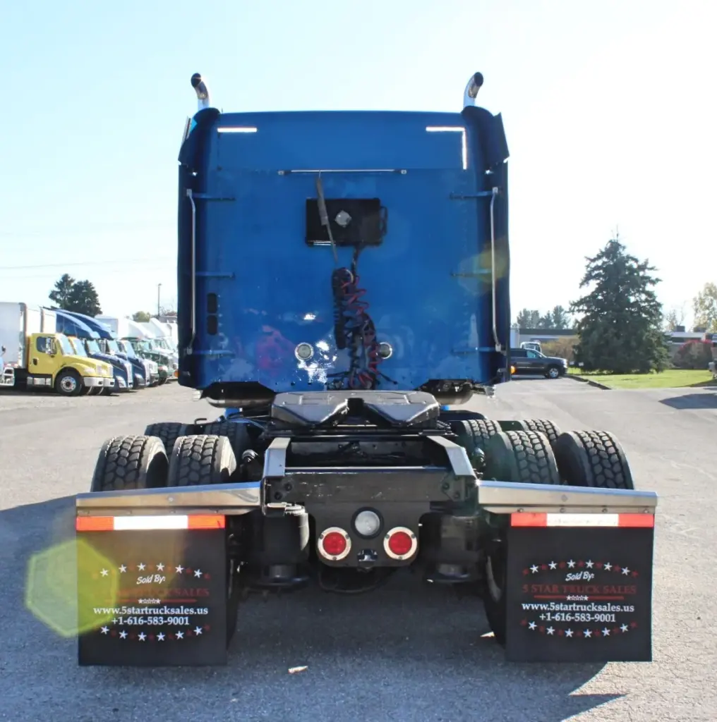 2016 Freightliner Coronado 132 — straight-on rear view of blue sleeper showing red taillights and tandem drive axles