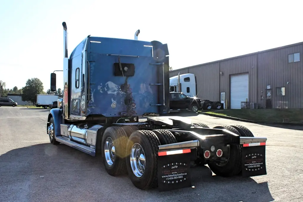2016 Freightliner Coronado 132 — angled view of blue sleeper's rear wall, chrome tanks and polished aluminum drive wheels