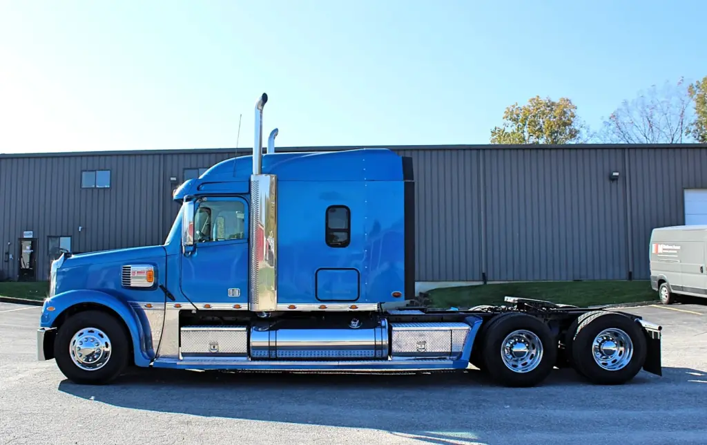 2016 Freightliner Coronado 132 — full-length view of blue sleeper cab and frame with chrome stacks and polished wheels