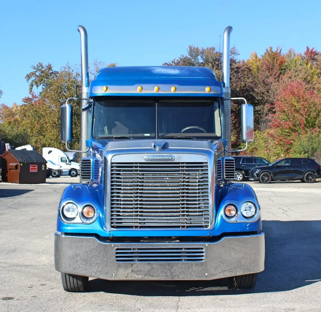 2016 Freightliner Coronado 132 — head-on front view of blue cab with twin chrome stacks, grille and amber cab lights