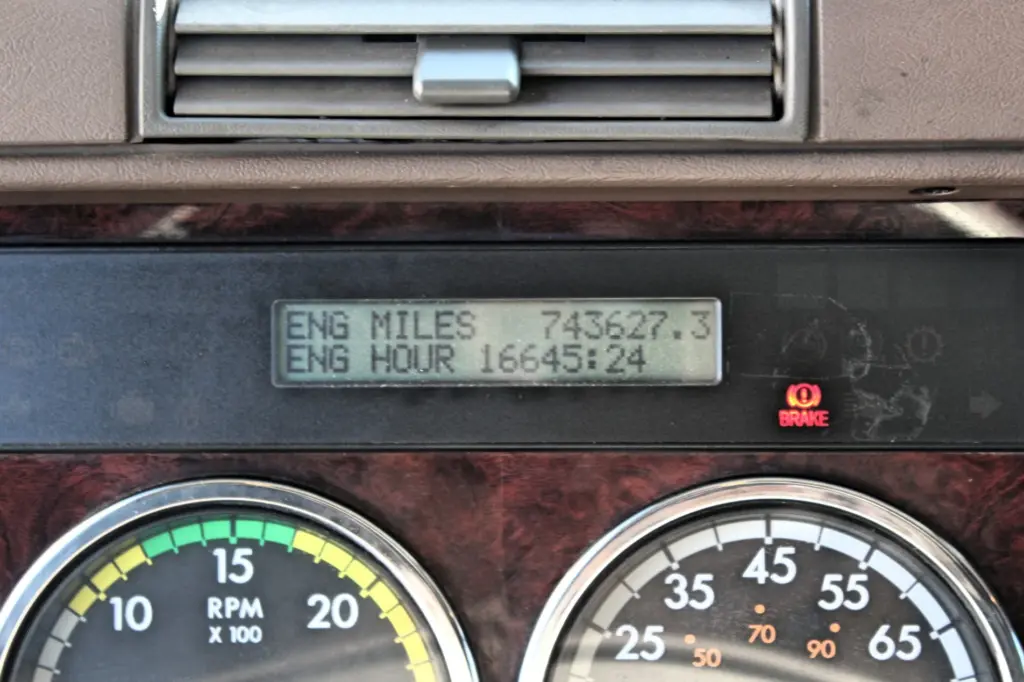 2016 Freightliner Coronado 132 — close view of digital display with engine miles and hours beside red brake lamp