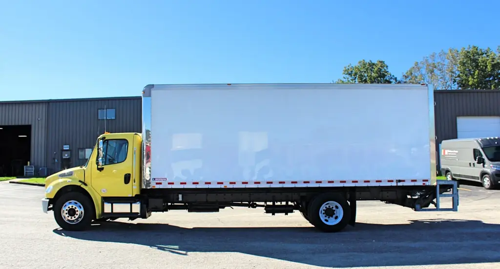 2016 Freightliner M2-106 Box Truck – full side view of yellow Freightliner with Morgan cargo box.