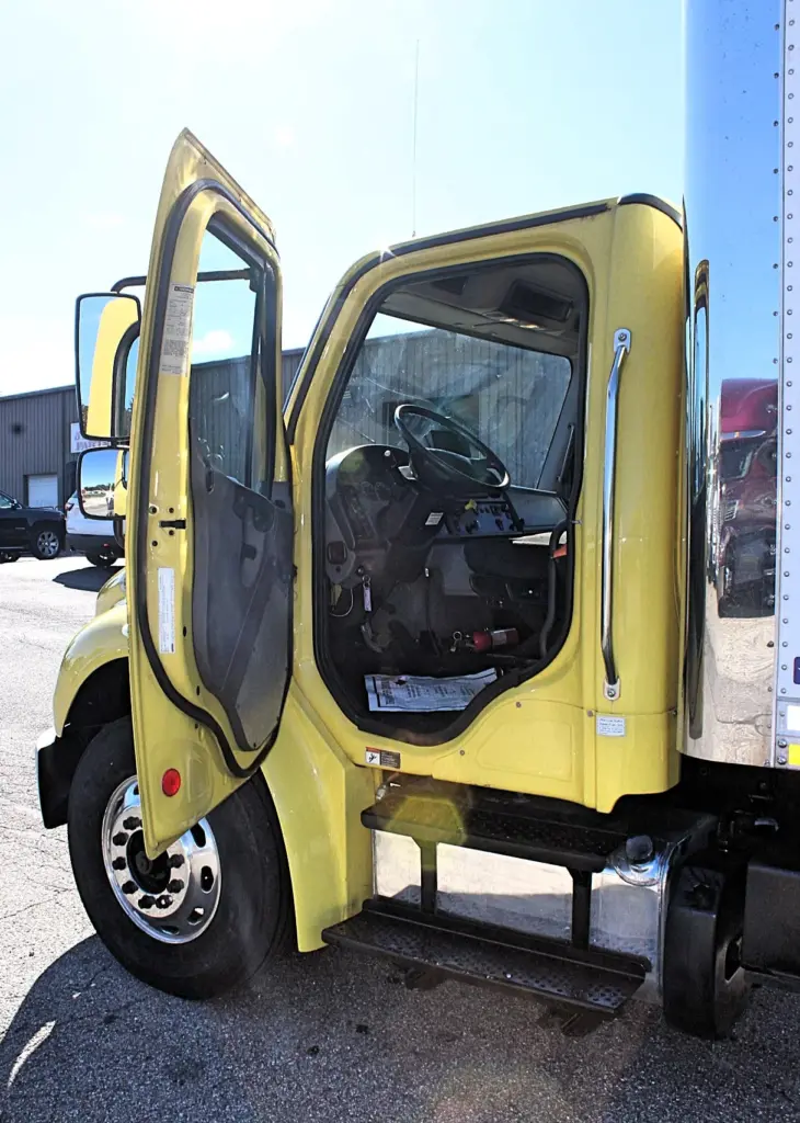 2016 Freightliner M2-106 Box Truck – driver door open showing cab entry steps and commercial truck interior.