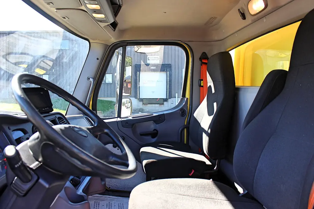 2016 Freightliner M2-106 Box Truck – clean cab interior showing driver and passenger seating.
