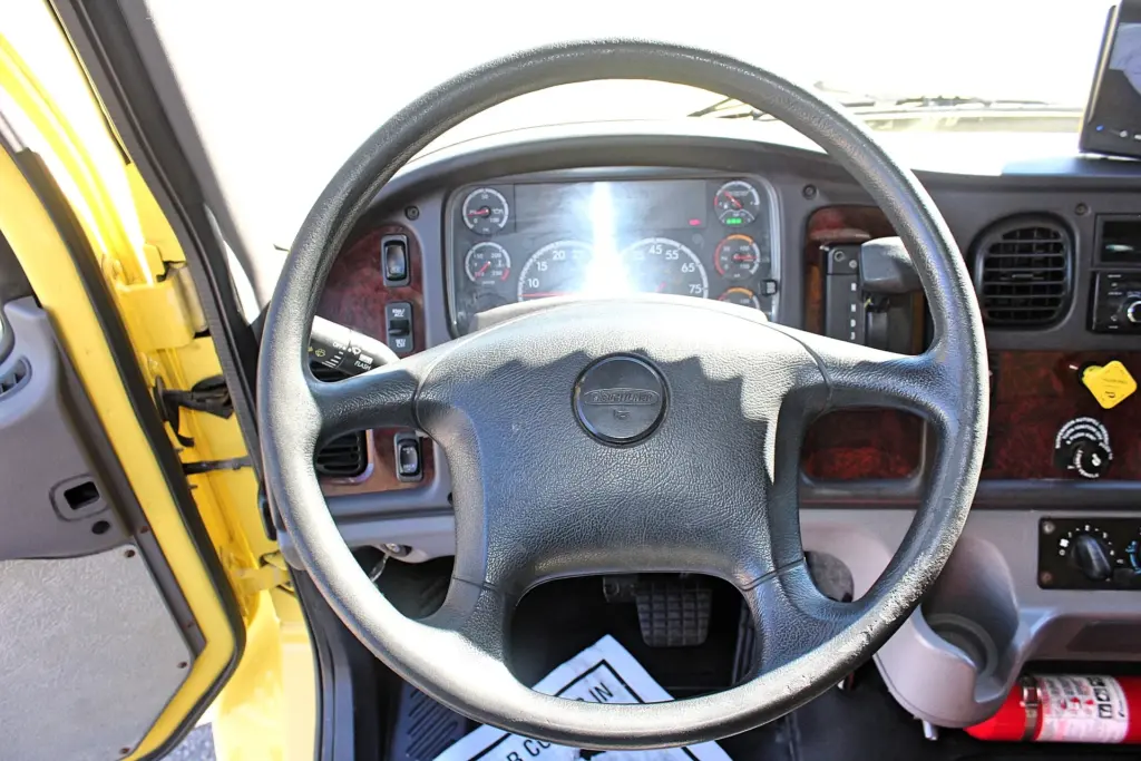 2016 Freightliner M2-106 Box Truck – driver cockpit showing steering wheel, gauges and dashboard controls.