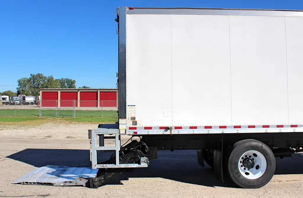 2016 Freightliner M2-106 Box Truck – rear section of white Morgan box body with hydraulic liftgate lowered and rear wheel visible.