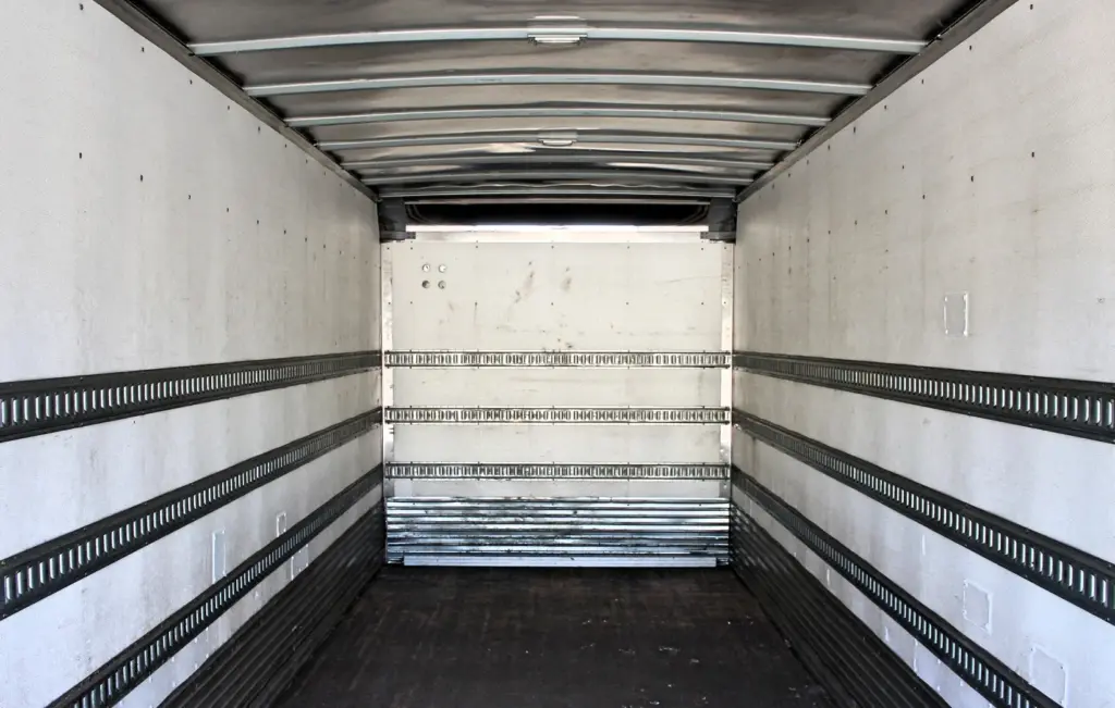 2016 Freightliner M2-106 Box Truck – wide interior view of Morgan cargo box showing wood floor, E-track rails and aluminum roof supports.