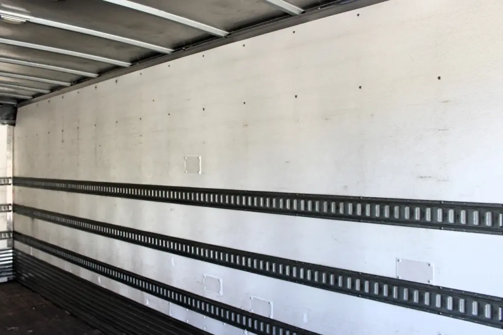 2016 Freightliner M2-106 Box Truck – interior cargo box side wall showing horizontal E-track cargo securement rails.