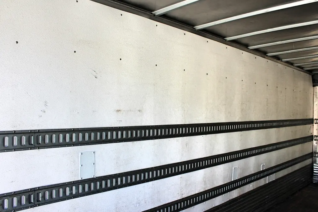 2016 Freightliner M2-106 Box Truck – opposite interior cargo wall with E-track rails, wall liner and roof supports.