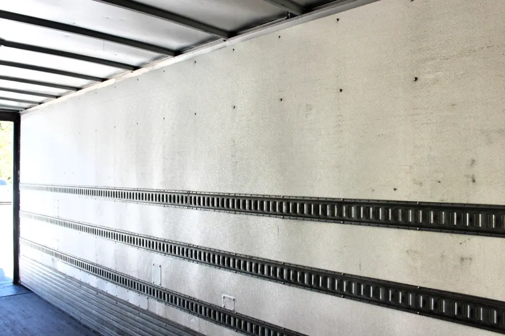 2016 Freightliner M2-106 Box Truck – cargo box interior side wall with multiple E-track rails and aluminum roof framing.