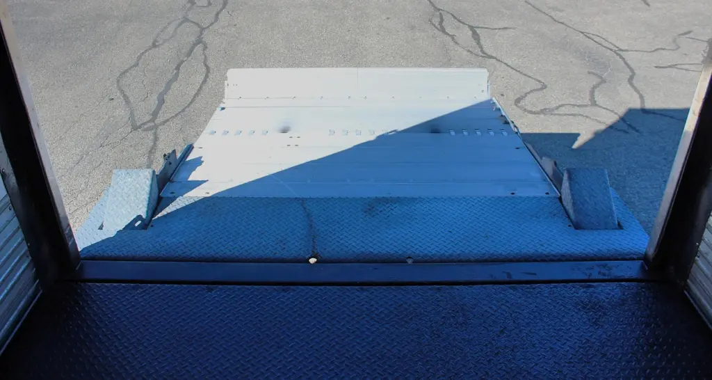 2016 Freightliner M2-106 Box Truck – view from inside the cargo box looking down over the rear threshold at the lowered liftgate.