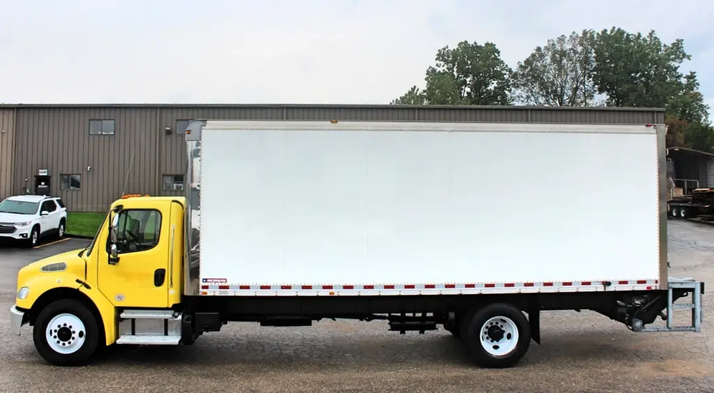 2016 Freightliner M2-106 box truck – full driver-side profile of yellow commercial box truck
