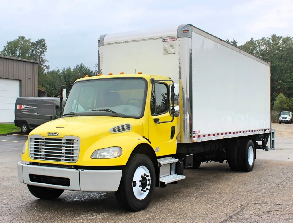 2016 Freightliner M2-106 box truck – front driver-side exterior view with yellow cab and white Morgan box