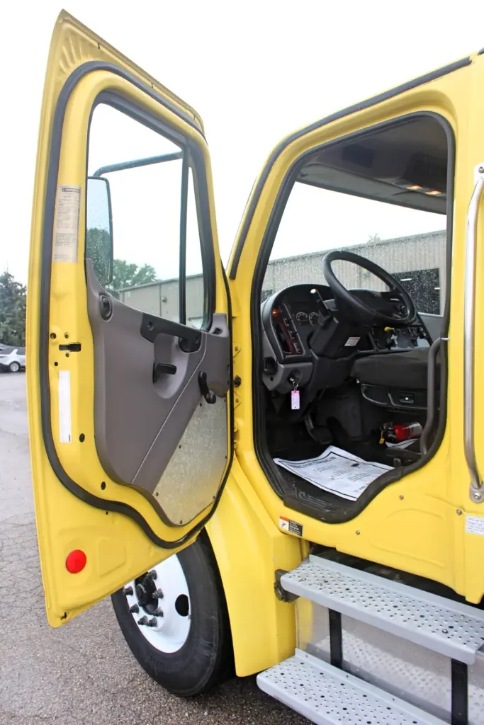2016 Freightliner M2-106 box truck – driver door open showing cab entry and interior