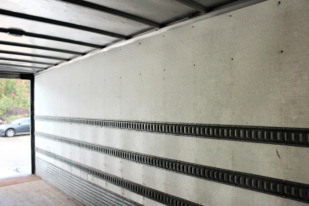 2016 Freightliner M2-106 box truck – cargo box interior showing wood floor, roof supports and E-track