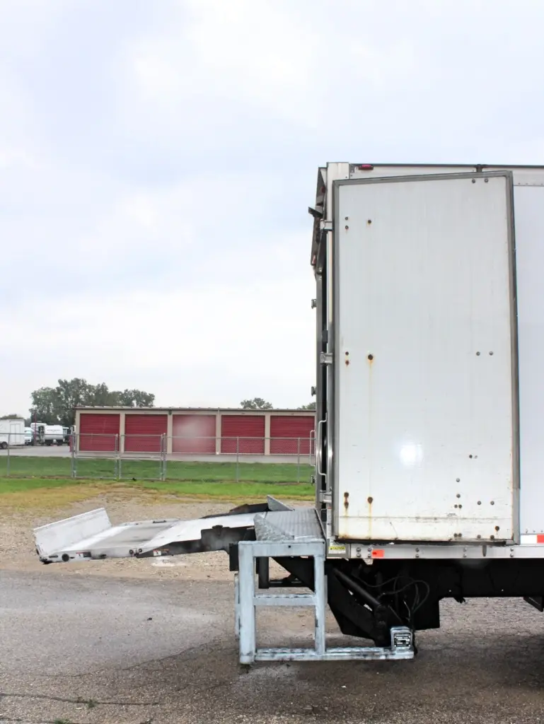 2016 Freightliner M2-106 box truck – rear-side view with cargo door open and liftgate deployed