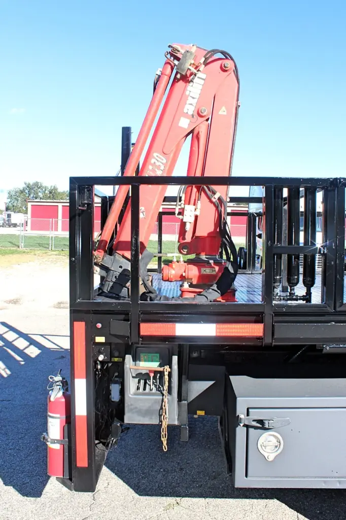 2018 Freightliner 114SD – rear-mounted red knuckle boom crane and hydraulic controls on stake bed truck.