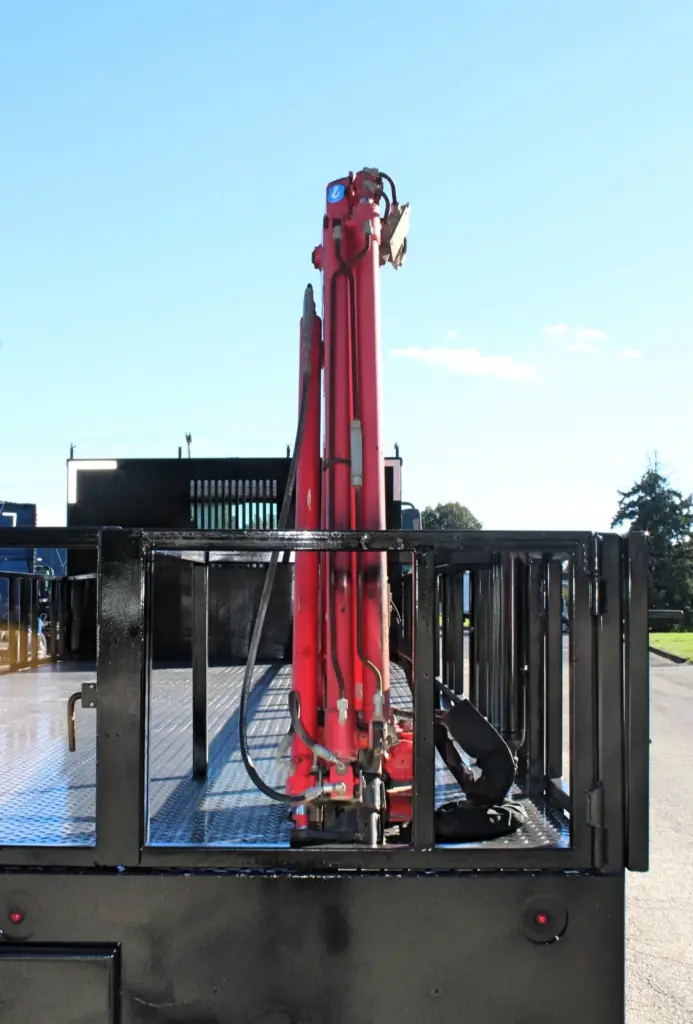 2018 Freightliner 114SD – rear view of folded knuckle boom crane mounted on heavy-duty flatbed body.
